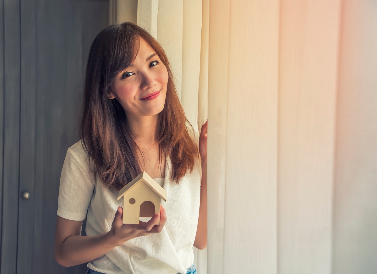 homeowner holding a miniature house