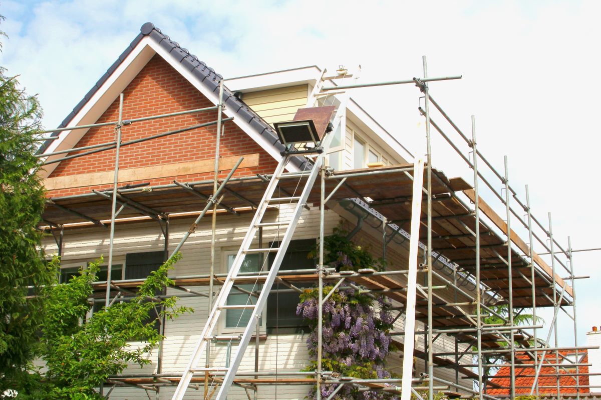 house with scaffolding outside under renovation