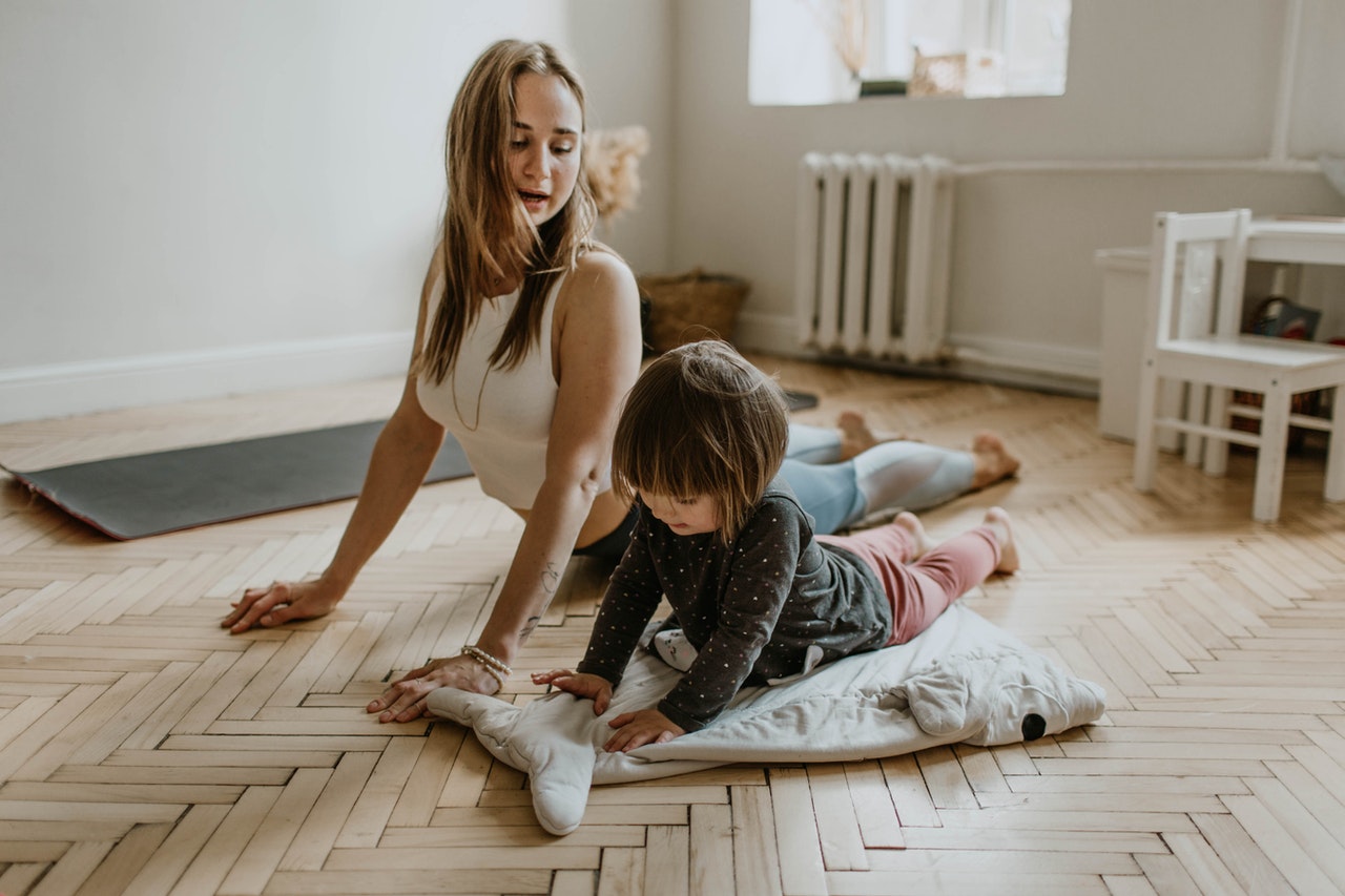 woman doing some exercise with her child