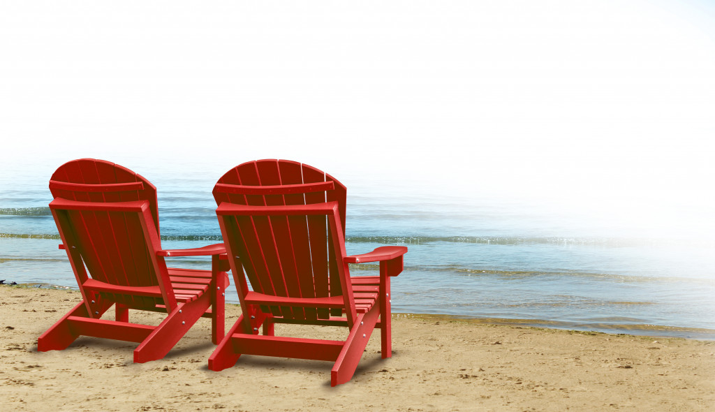 2 red chairs on the beachside