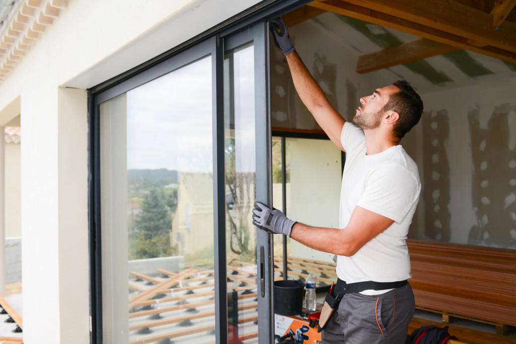 man installing glass windows