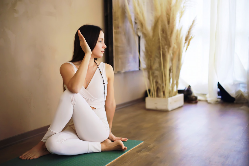 Woman performing yoga exercises at a wellness hub at home.