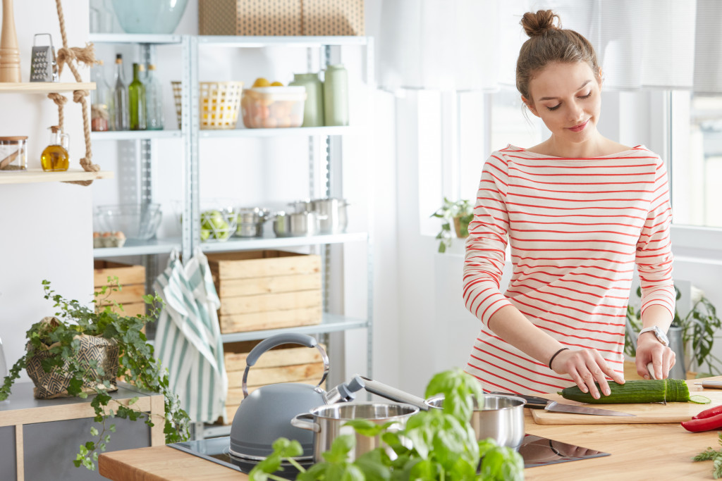 Woman preparing healthy meal in summer kitchen