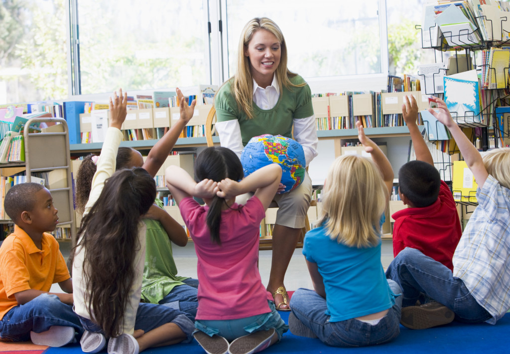 Children raising their hands in a classroom