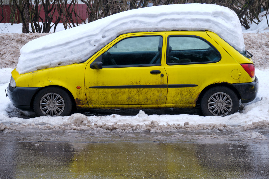 A car with full layer of snow