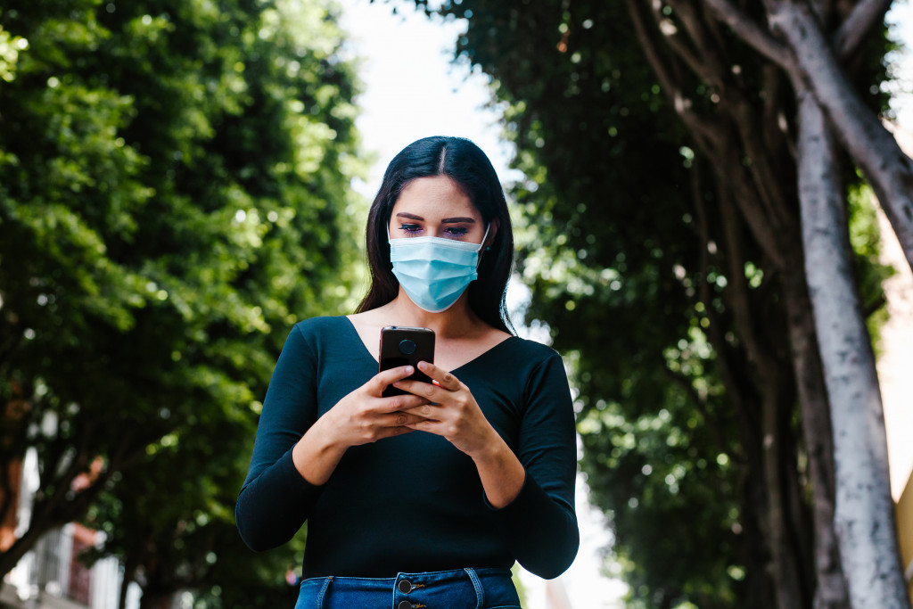 A woman wearing a mask while walking