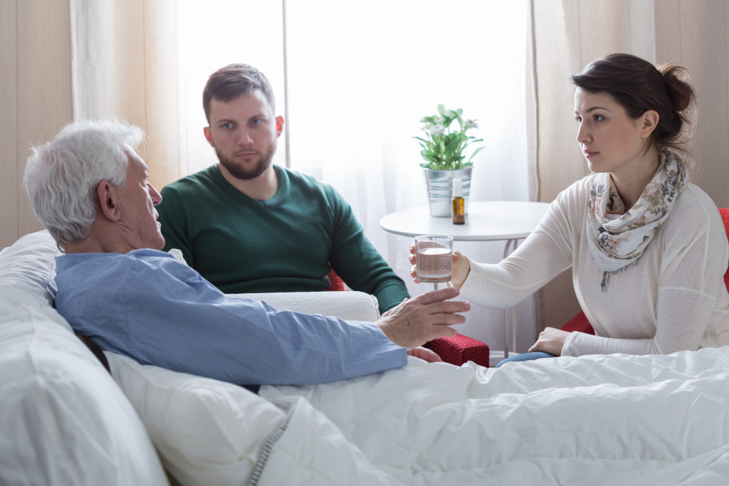 old patient with his children in a hospital