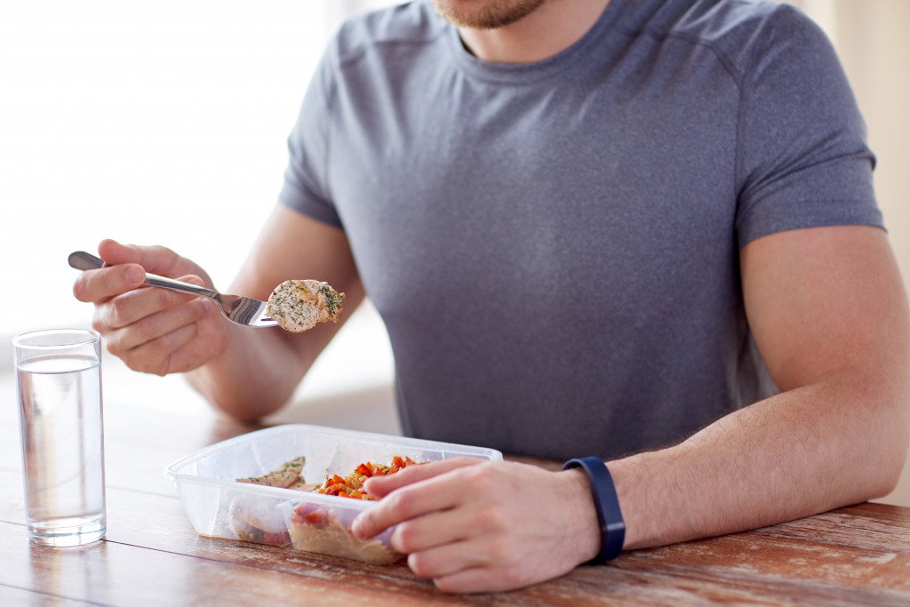 A man eating healthy food on the counter