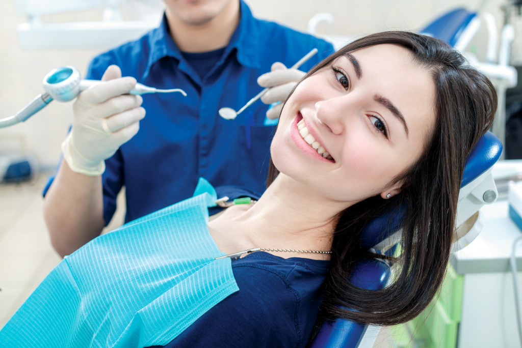 young smiling dental patient in the chair