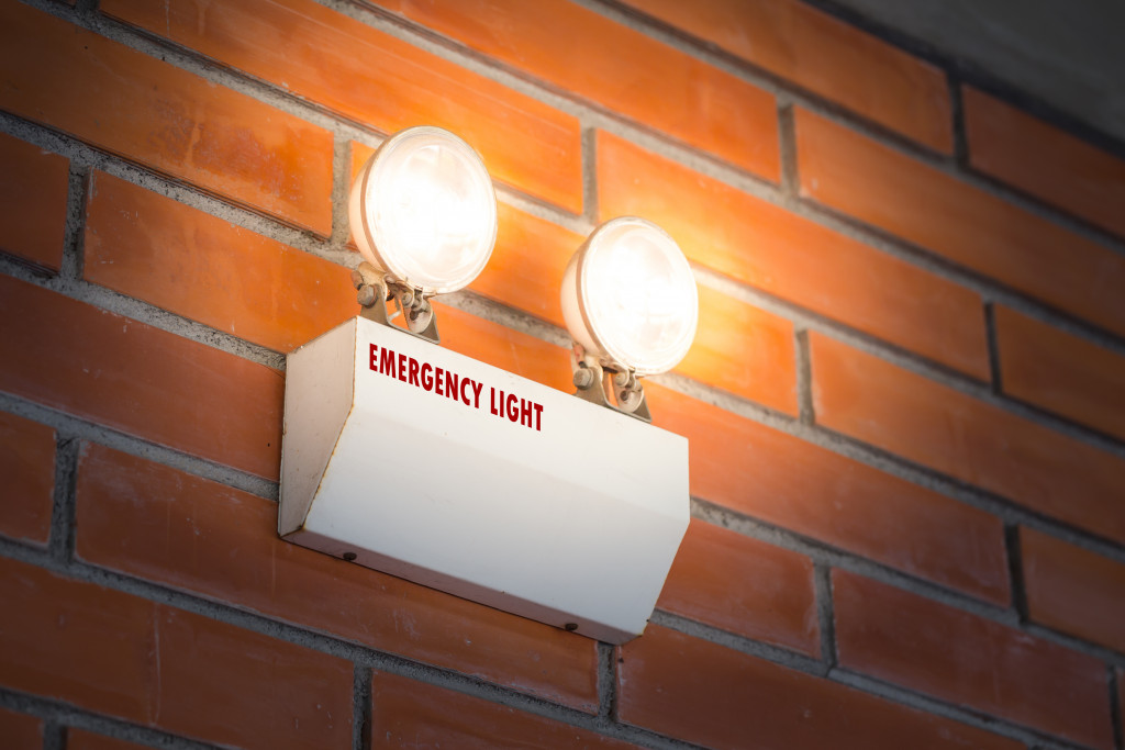 An emergency light installed on a brick wall