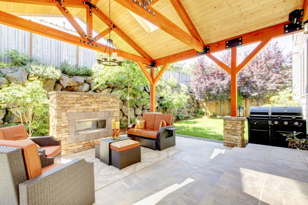 A covered modern patio with a fireplace