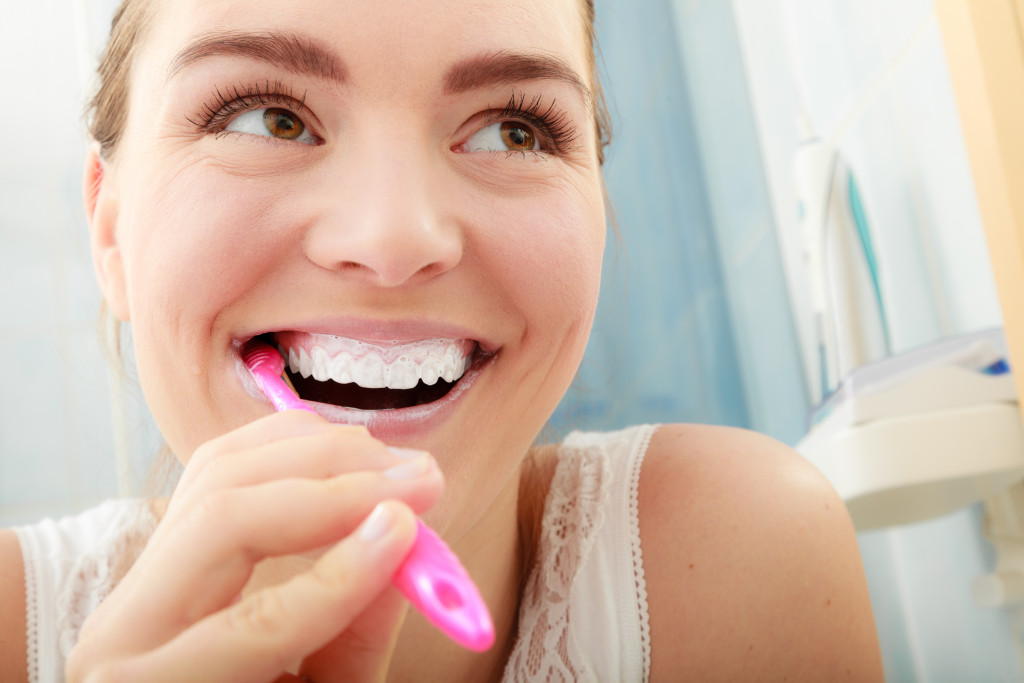 Girl with toothbrush in bathroom. Oral hygiene