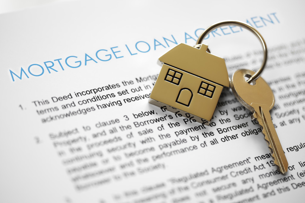 A mortgage loan agreement document with house keys