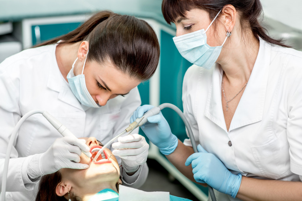 dentists cleaning a patients mouth