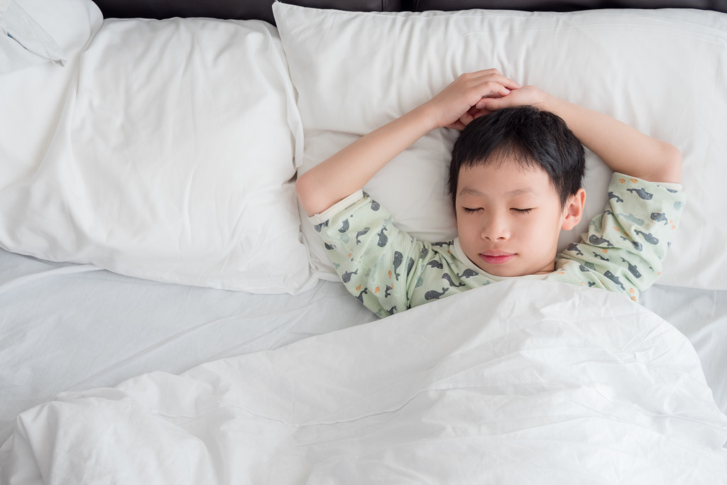 A young boy sleeping in bed