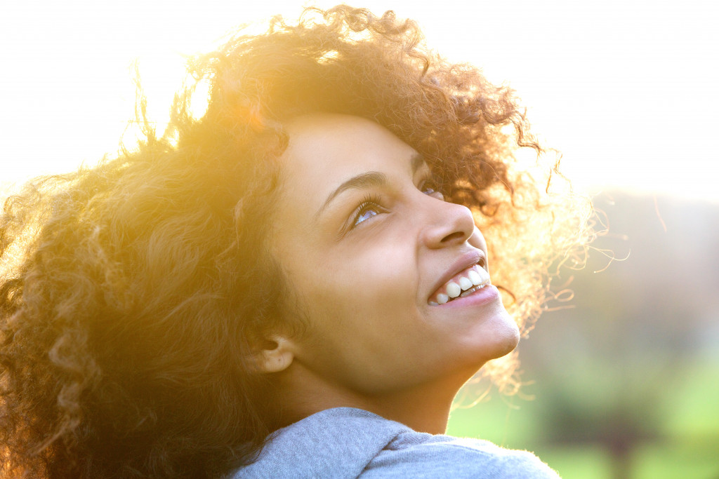 a beautiful woman smiling and looking up