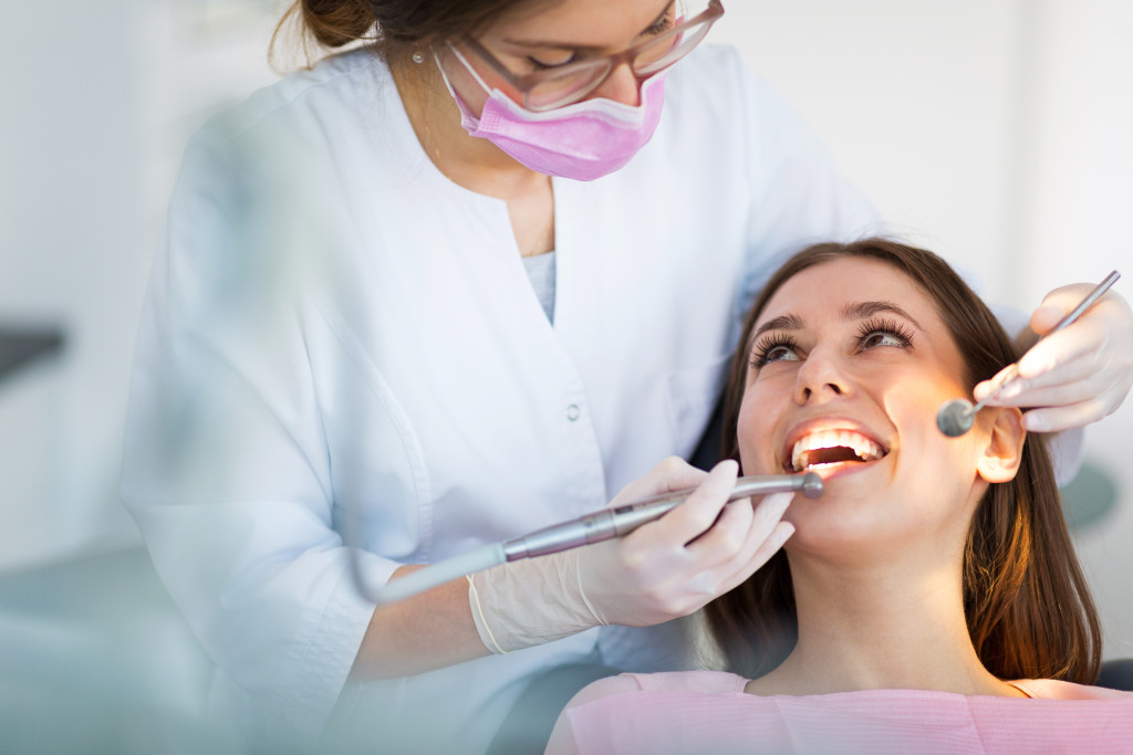 a dentist examining patients mouth