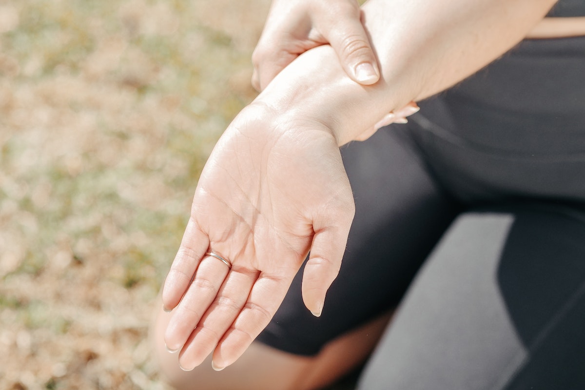 Close-Up Photo of a Woman Stretching Her Wrist 