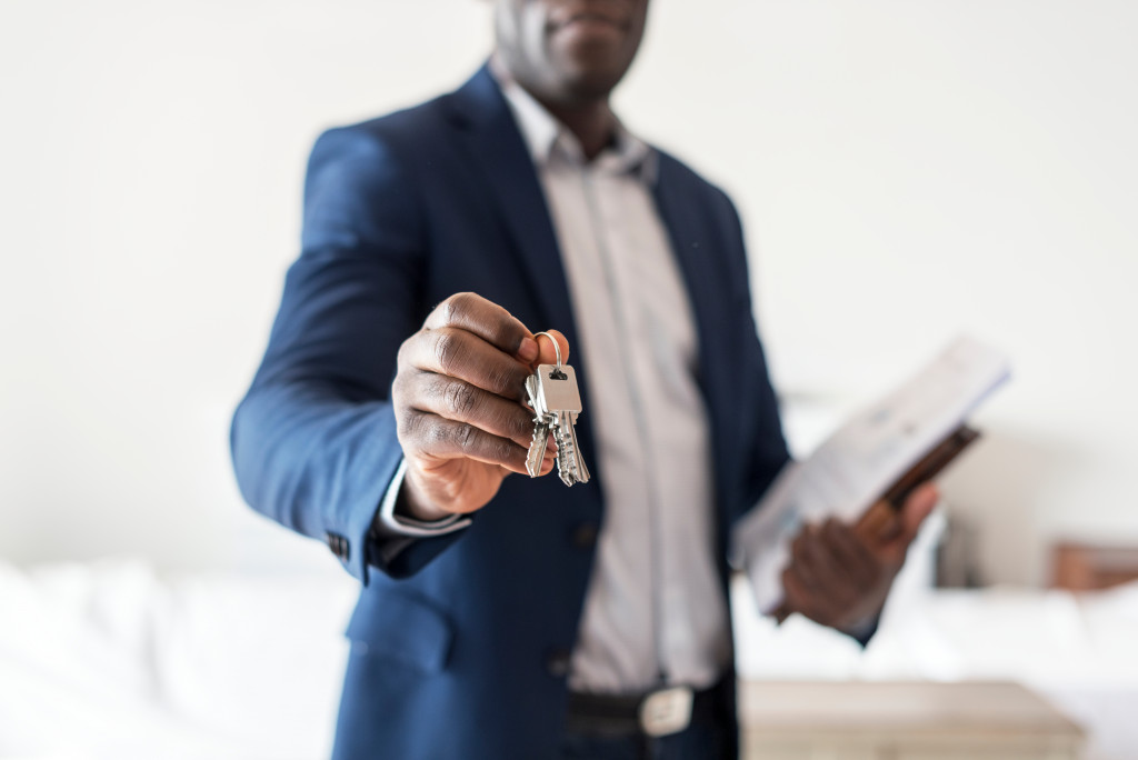 A real estate agent holding the keys to a new home