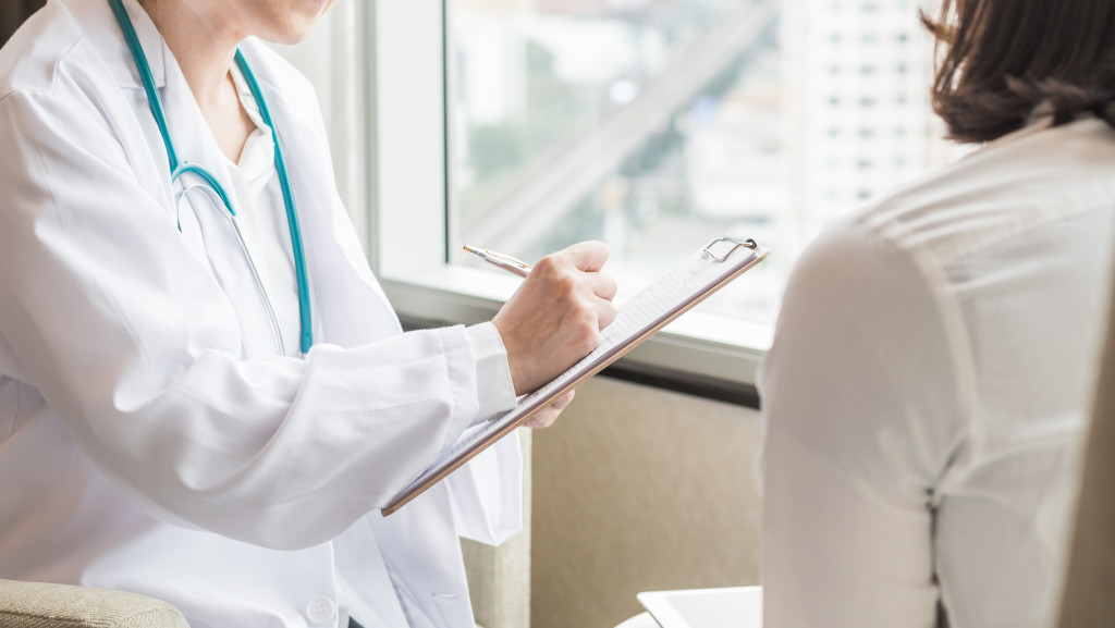 A woman talking to a doctor in a clinic