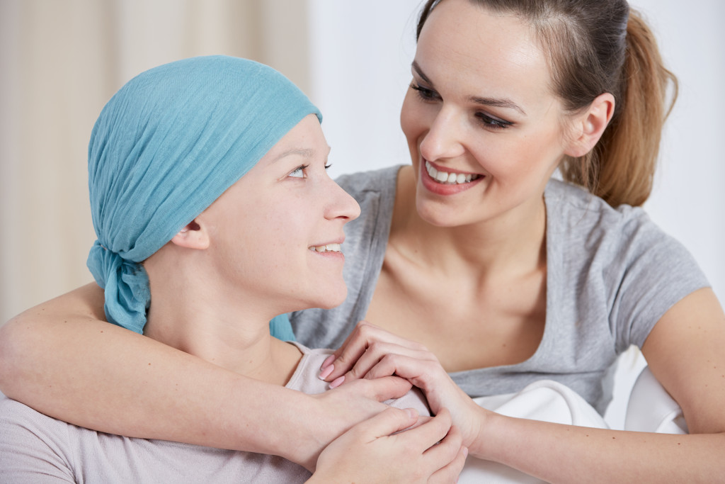 a woman with cancer and a smiling young woman