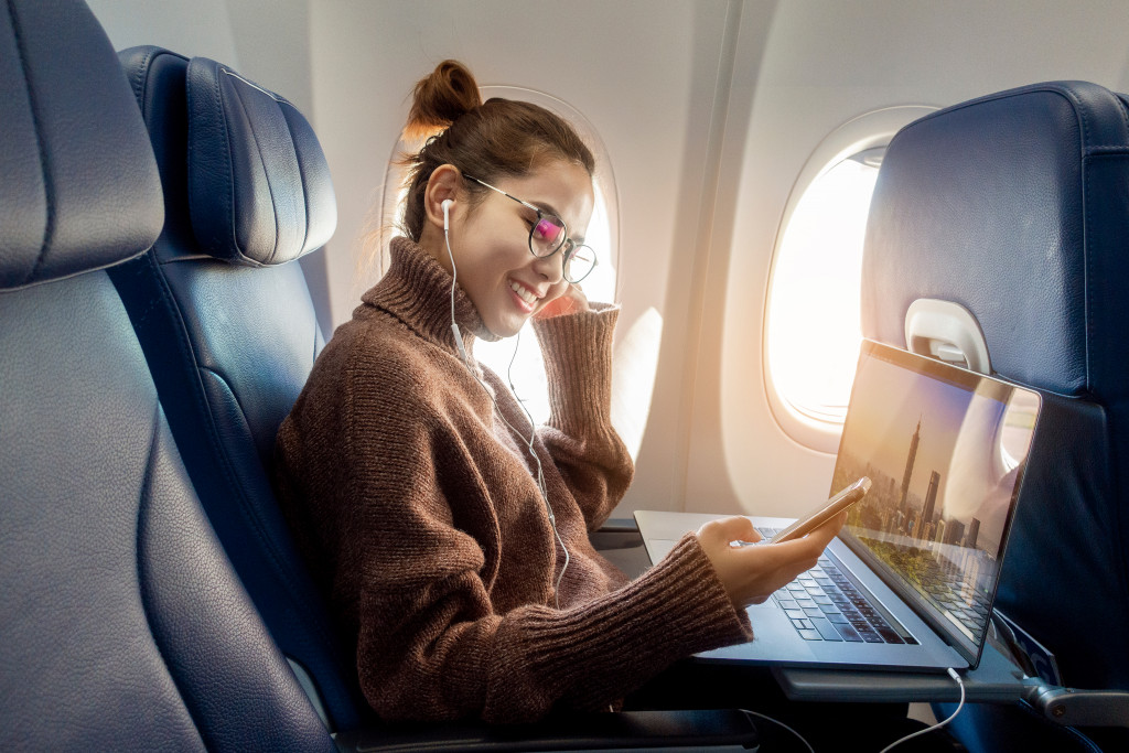 woman smiling while checking her phone