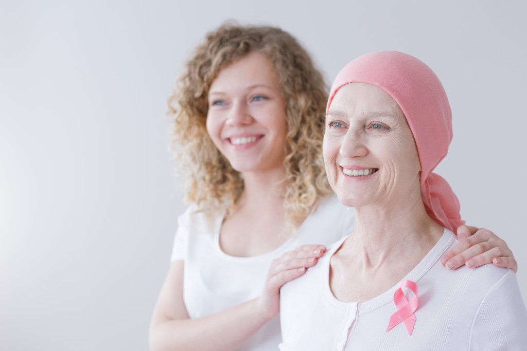 a mother and daughter smiling on white background