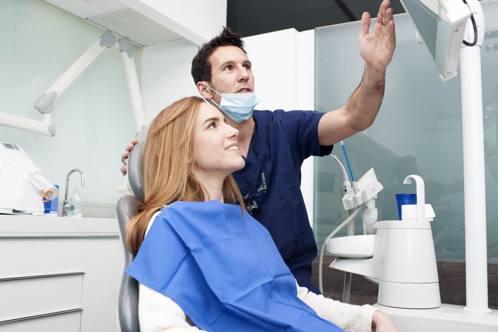 woman smiling in the dental clinic waiting to get implants