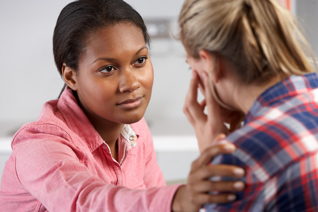 A psychiatrist comforting a girl