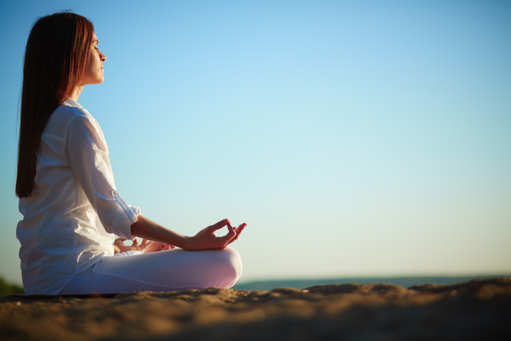 Young woman meditating outdoors.