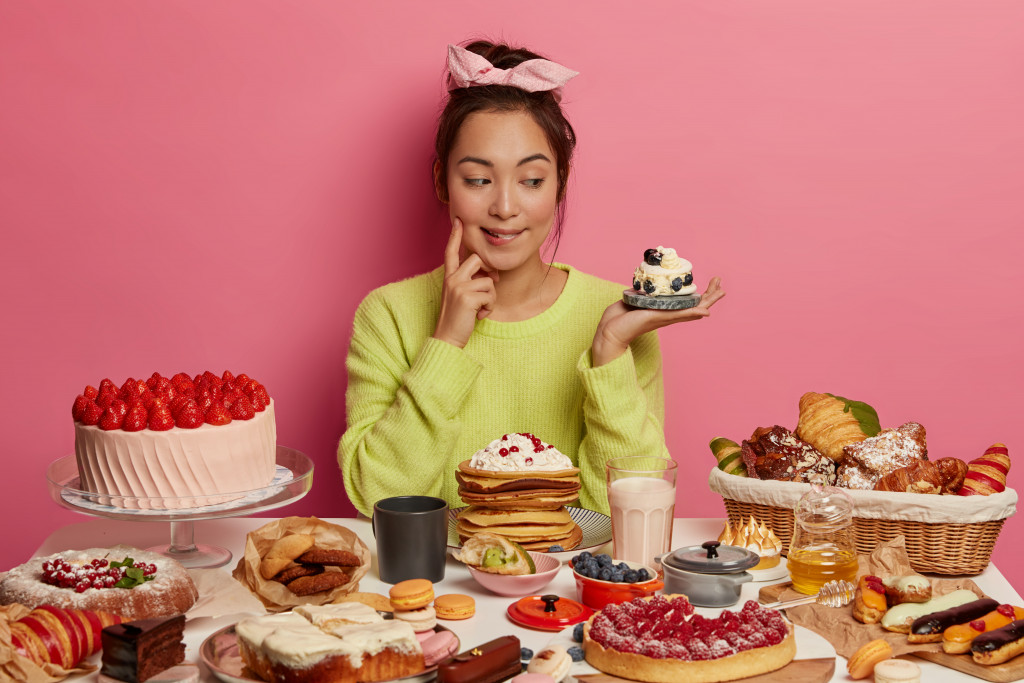 woman eating lots of sweets