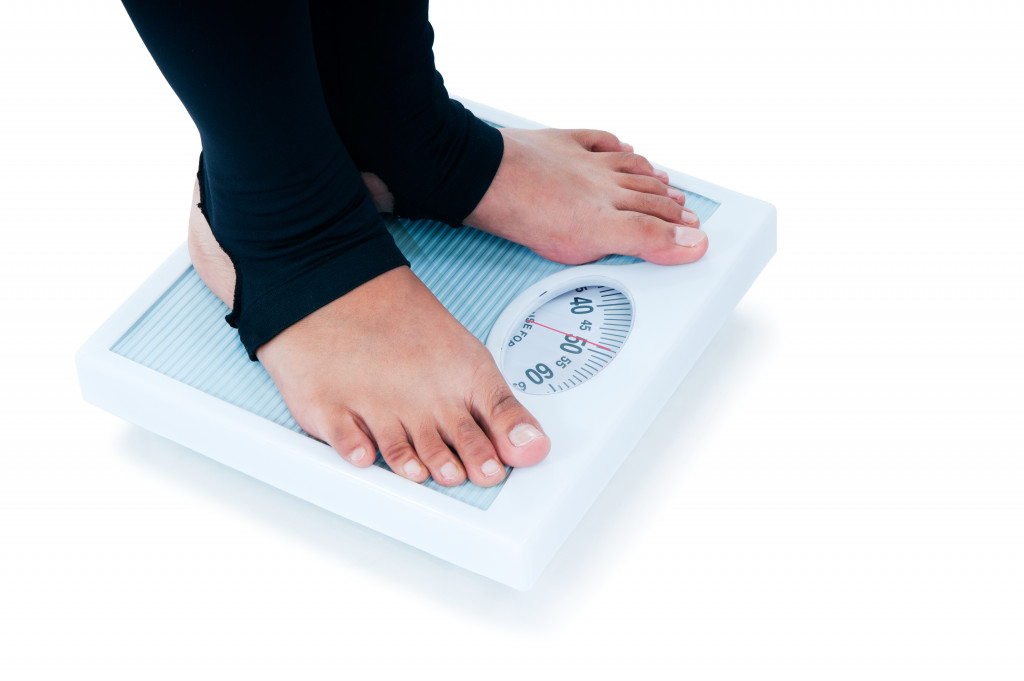 A person standing on a weighing scale